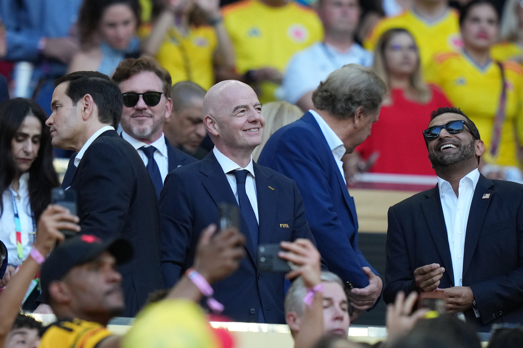 FIFA President Gianni Infantino, center, stands with United States Secretary of State Marco Rubio, left, and FBI Director Kash Patel during the World Cup Group K soccer match between Colombia and Portugal in Miami Gardens, Fla., Saturday, June 27, 2026. (AP Photo/Lynne Sladky)