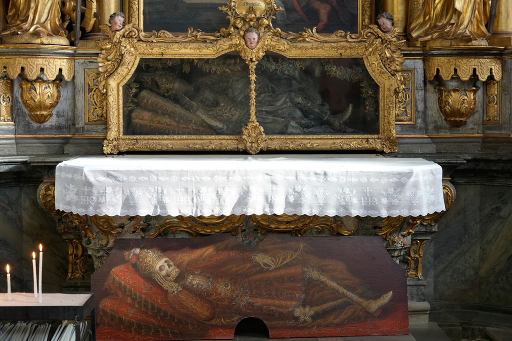 An elaborately decorated skeleton lies in the catholic monastery church of Banz in Bad Staffelstein, Germany, Saturday, May 2, 2026. (AP Photo/Matthias Schrader)