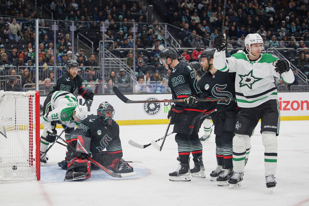 Dallas Stars defenseman Esa Lindell, right, reacts after scoring as Seattle Kraken goalie Joey Daccord (35) looks on during the second period of an NHL hockey game Wednesday, Nov. 26, 2025, in Seattle. (AP Photo/Jason Redmond)