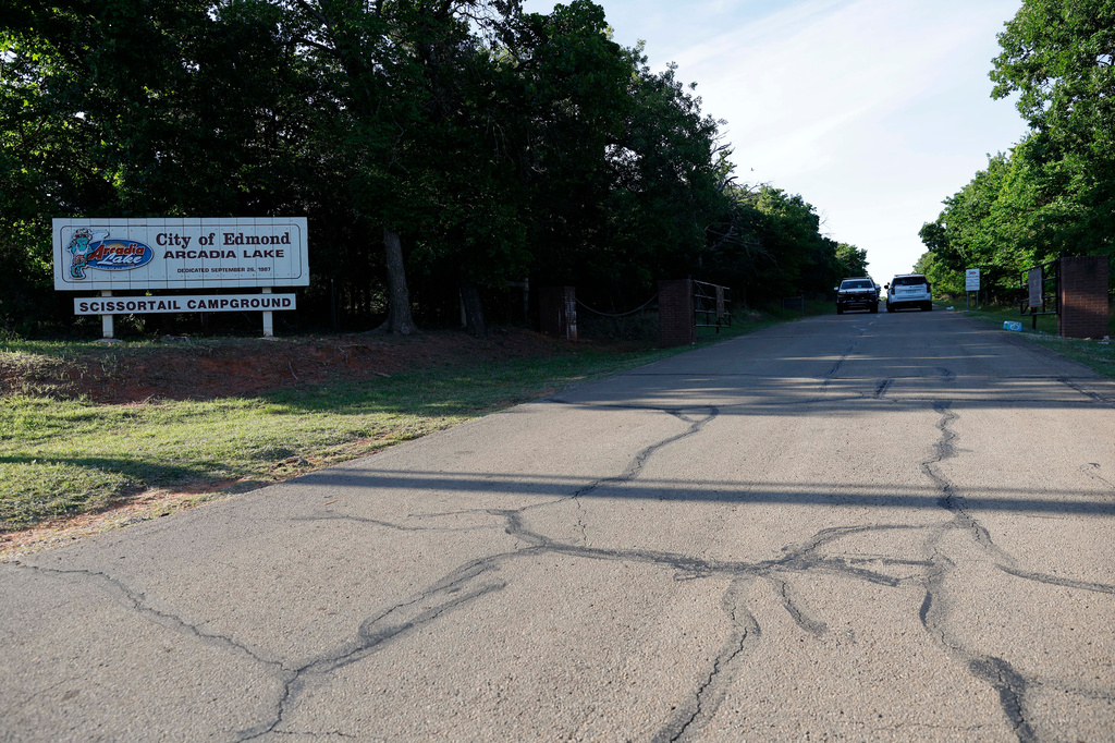 Officials block the entrance to Scissortail Campground at Arcadia Lake, Monday, May 4, 2026, in Edmond, Okla., after a shooting on Sunday evening. (AP Photo/Alonzo Adams)