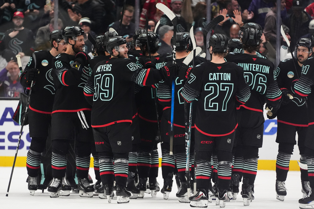 The Seattle Kraken celebrate after beating the Detroit Red Wings in a shootout in an NHL hockey game Tuesday, Oct. 20, 2026, in Seattle. (AP Photo/Lindsey Wasson)