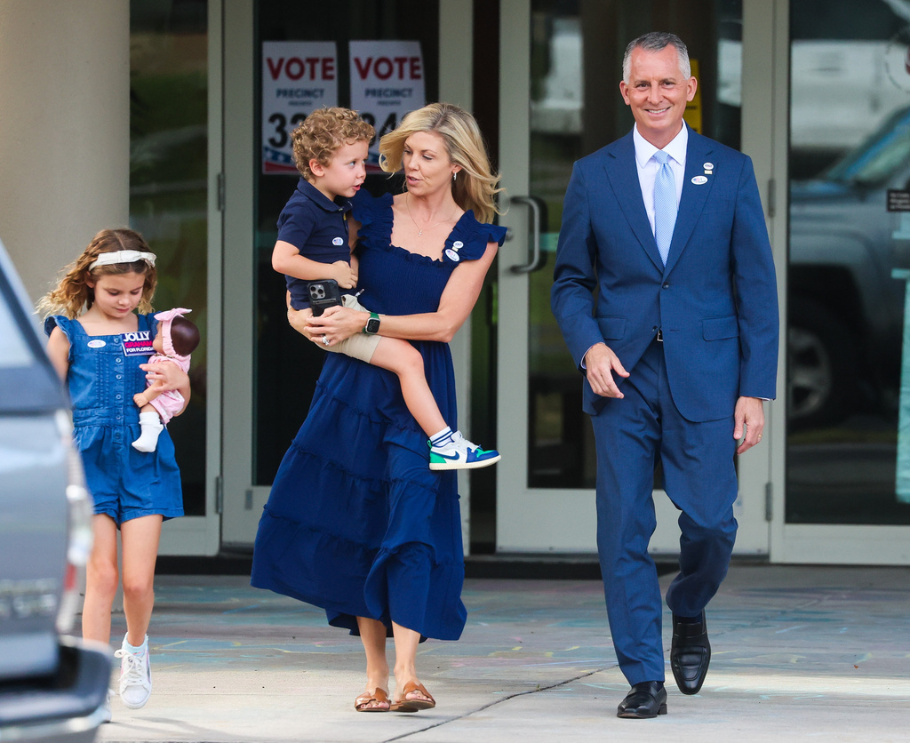 Florida Democratic gubernatorial candidate David Jolly along with his family after voting at his home precinct, the Anona United Methodist Church, Tuesday, Aug. 18, 2026 in Largo, Fla. From left is daughter CeCe, son Teddy and wife Laura. (Dirk Shadd/Tampa Bay Times via AP)