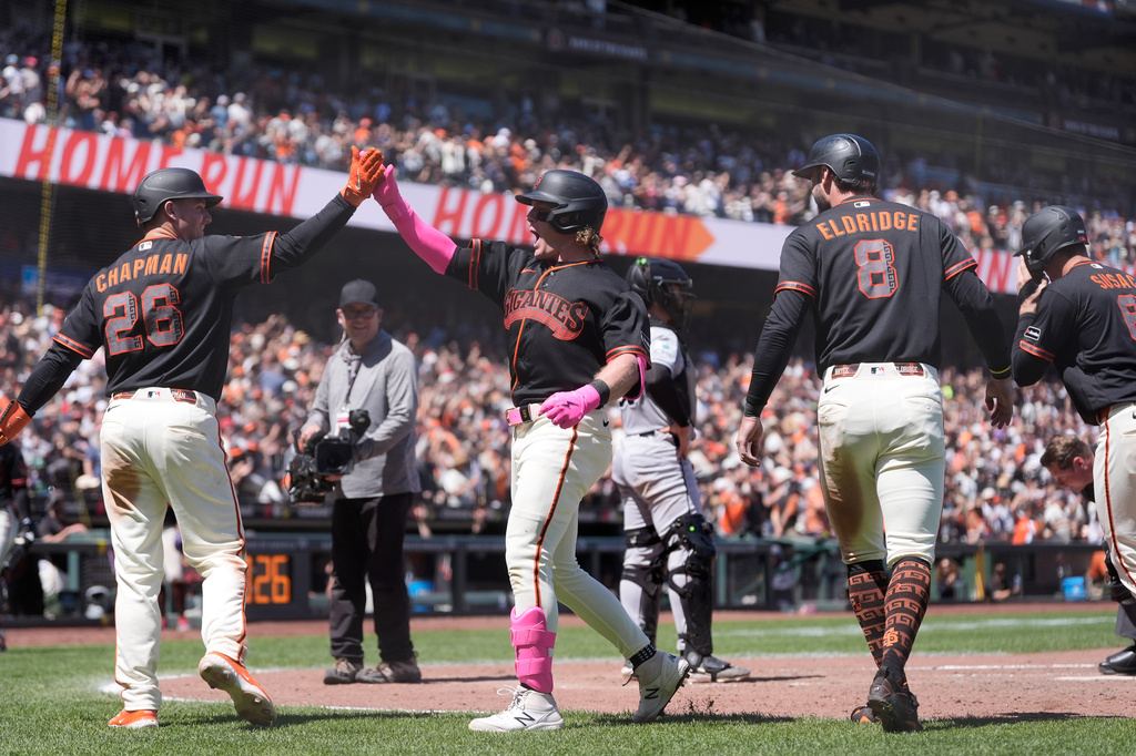 San Francisco Giants' Harrison Bader, middle, celebrates after hitting a grand slam that also scored Matt Chapman (26), Bryce Eldridge (8) and Daniel Susac, right, during the fifth inning of a baseball game against the Chicago White Sox Saturday, May 23, 2026, in San Francisco. (AP Photo/Jeff Chiu)