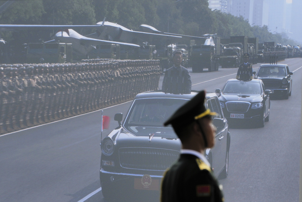 Chinese President Xi Jinping is shown on a giant screen as he inspects the military parade to commemorate the 80th anniversary of Japan's World War II surrender held in front of Tiananmen Gate in Beijing, Wednesday, Sept. 3, 2025. (AP Photo/Andy Wong)