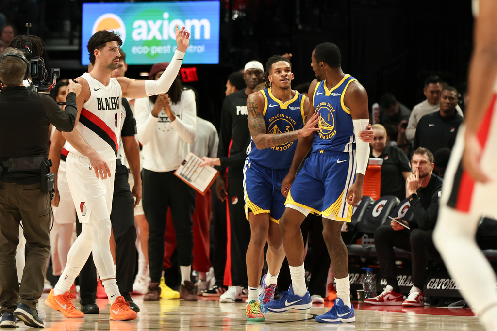 Golden State Warriors forward Jonathan Kuminga (1), right, reacts after receiving a technical foul during the first half of an NBA preseason basketball game against the Portland Trail Blazers Tuesday, Oct. 14, 2025, in Portland, Ore. (AP Photo/Amanda Loman)