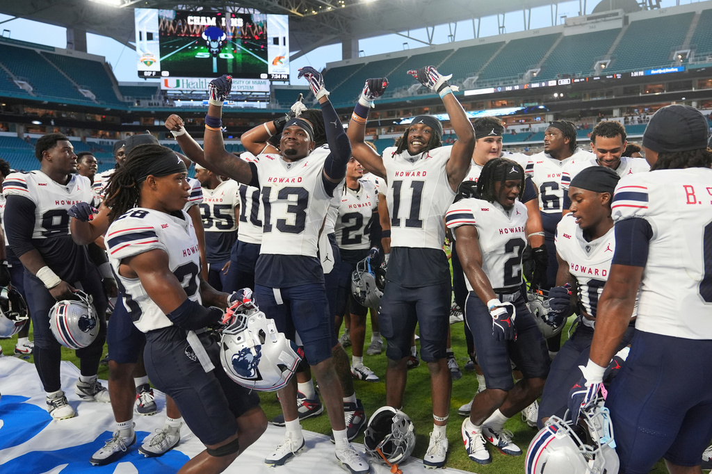 FILE - Howard players celebrate after defeating Florida A&M in the Orange Blossom Classic NCAA college football game, Aug. 30, 2025, in Miami Gardens, Fla. (AP Photo/Lynne Sladky, File)