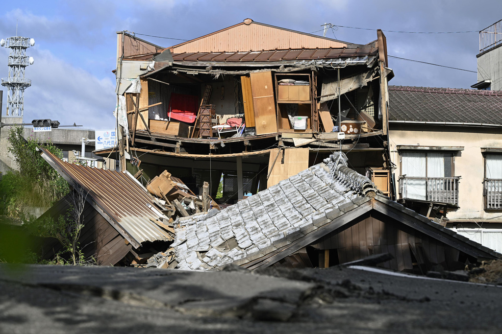 The roof and wall of a building are seen fallen, a day after an earthquake in Yatsushiro, Kumamoto prefecture, Wednesday, July 29, 2026.(Yu Nakajima/Kyodo News via AP)