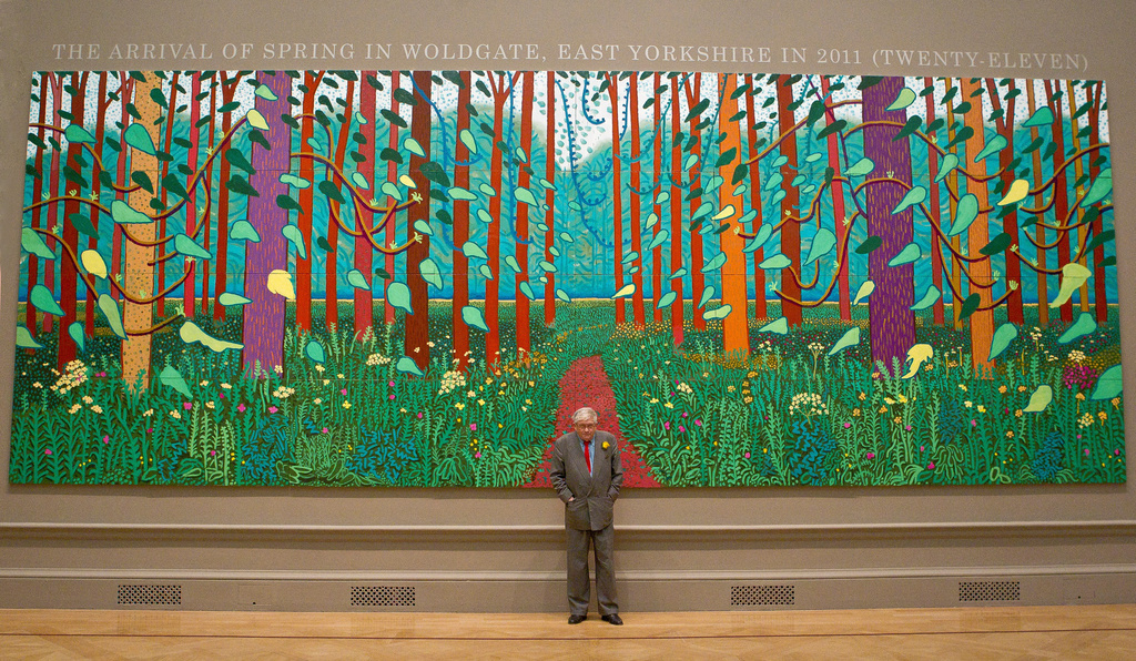 FILE - British artist David Hockney stands before one of his paintings of the East Yorkshire landscape at The Royal Academy of Arts in Piccadilly, London, Monday, Jan. 16, 2012, ahead of his exhibition called 'A Bigger Picture'. (AP Photo/Joel Ryan)