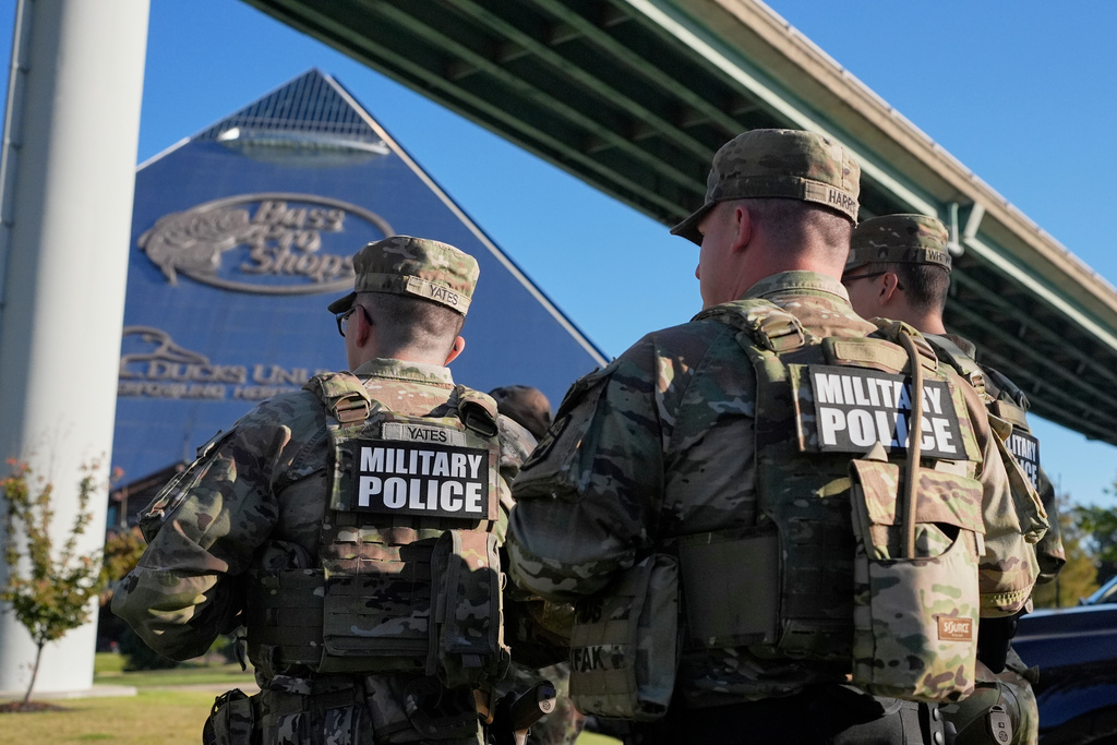 Members of National Guard patrol outside a Bass Pro Shops, Friday, Oct. 10, 2025, in Memphis, Tenn. (AP Photo/George Walker IV)