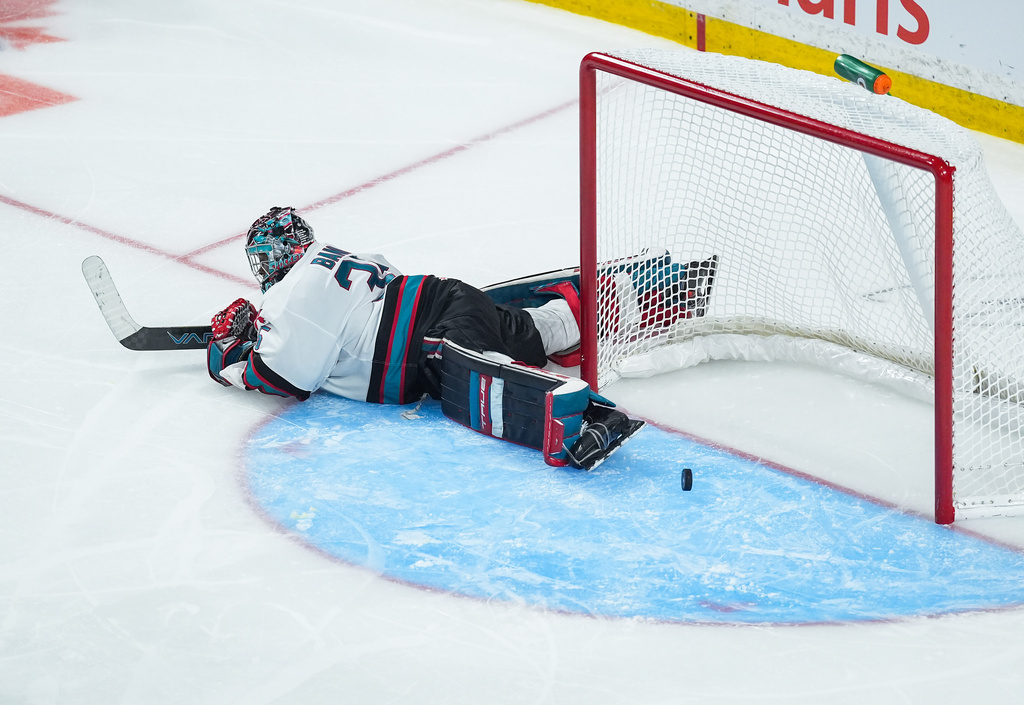Kelowna Rockets goalie Josh Banini lies on the ice after allowing the winning goal to Chicoutimi Sagueneens' Liam Lefebvre during the first overtime period of a Memorial Cup hockey game in Kelowna, British Columbia, Sunday, May 24, 2026. (Darryl Dyck/The Canadian Press via AP)