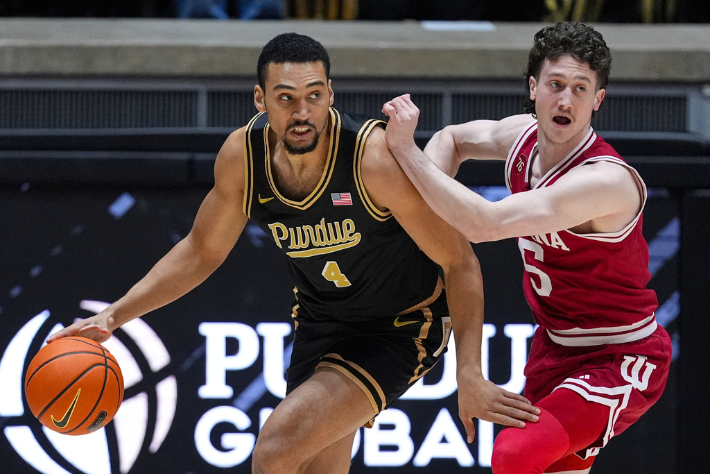 Indiana guard Conor Enright (5) defends Purdue forward Trey Kaufman-Renn (4) during the first half of an NCAA college basketball game in West Lafayette, Ind., Friday, Feb. 20, 2026. (AP Photo/Michael Conroy)