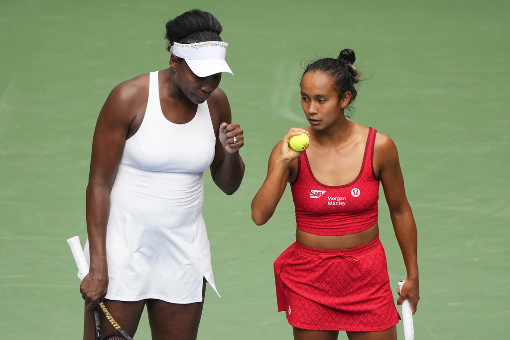 Venus Williams, of the United States, left, and Leylah Fernandez, of Canada, talk on the court during a first round women's doubles match against Lyudmyla Kichenok, of the Czech Republic and Ellen Perez, of Australia, during the U.S. Open tennis championships, Thursday, Aug. 28, 2025, in New York. (AP Photo/Yuki Iwamura)