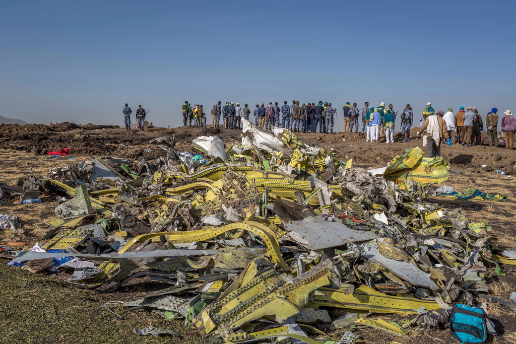 FILE - Wreckage is piled at the crash scene of Ethiopian Airlines flight ET302 near Bishoftu, Ethiopia, March 11, 2019. (AP Photo/Mulugeta Ayene, File)