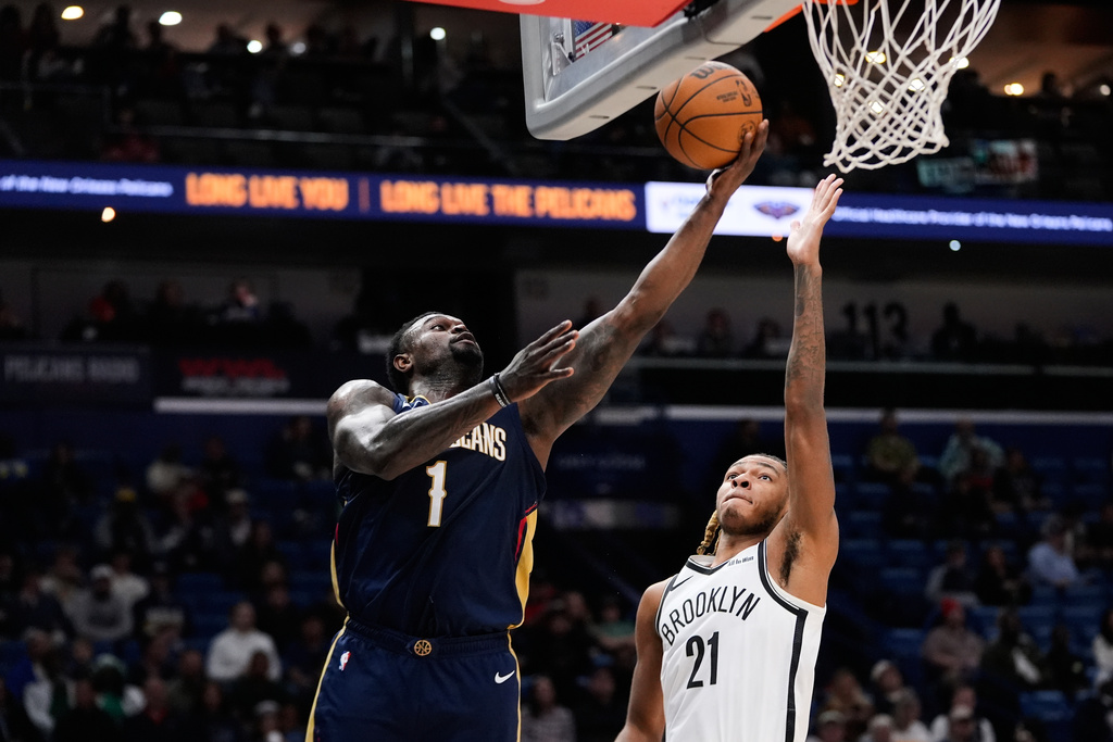 New Orleans Pelicans forward Zion Williamson (1) goes to the basket against Brooklyn Nets forward Noah Clowney (21) in the first half of an NBA basketball game, Wednesday, Jan. 14, 2026, in New Orleans. (AP Photo/Gerald Herbert)