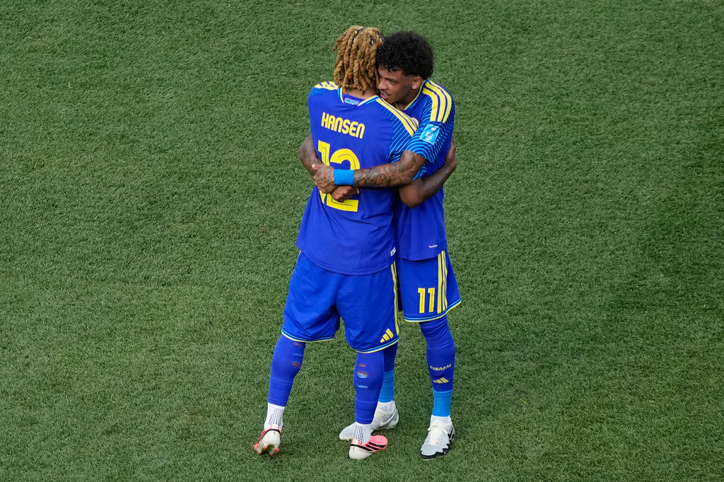 Curaçao's Sontje Hansen (12) and Curaçao's Jeremy Antonisse (11) embrace after the World Cup Group E soccer match between Curacao and Ivory Coast in Philadelphia, Thursday, June 25, 2026. (AP Photo/Matt Slocum)