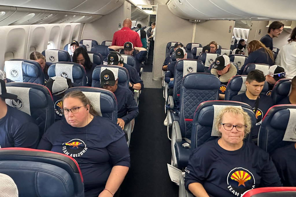 Members of teams from Arizona and New Mexico sit in their seats after boarding their flight to the 2026 Special Olympics USA Games Friday, June 19, 2026. (AP Photo/John Marshall)