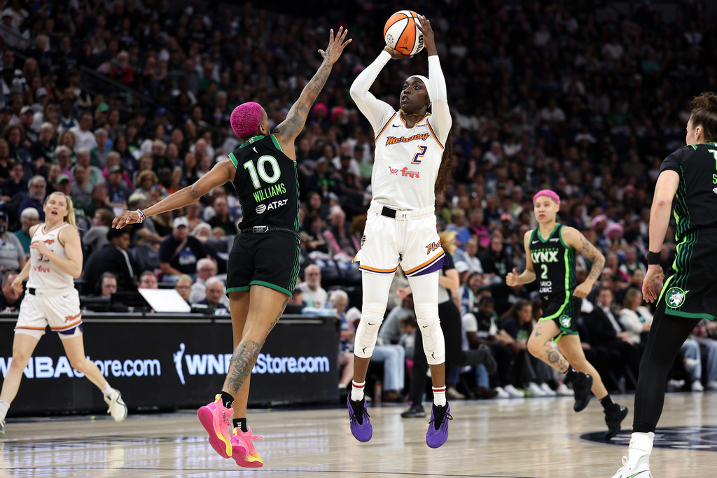 Phoenix Mercury guard Kahleah Copper (2) shoots the ball as Minnesota Lynx guard Courtney Williams (10) defends during the first half of Game 2 of a WNBA basketball playoff semifinals series Tuesday, Sept. 23, 2025, in Minneapolis. (AP Photo/Matt Krohn)