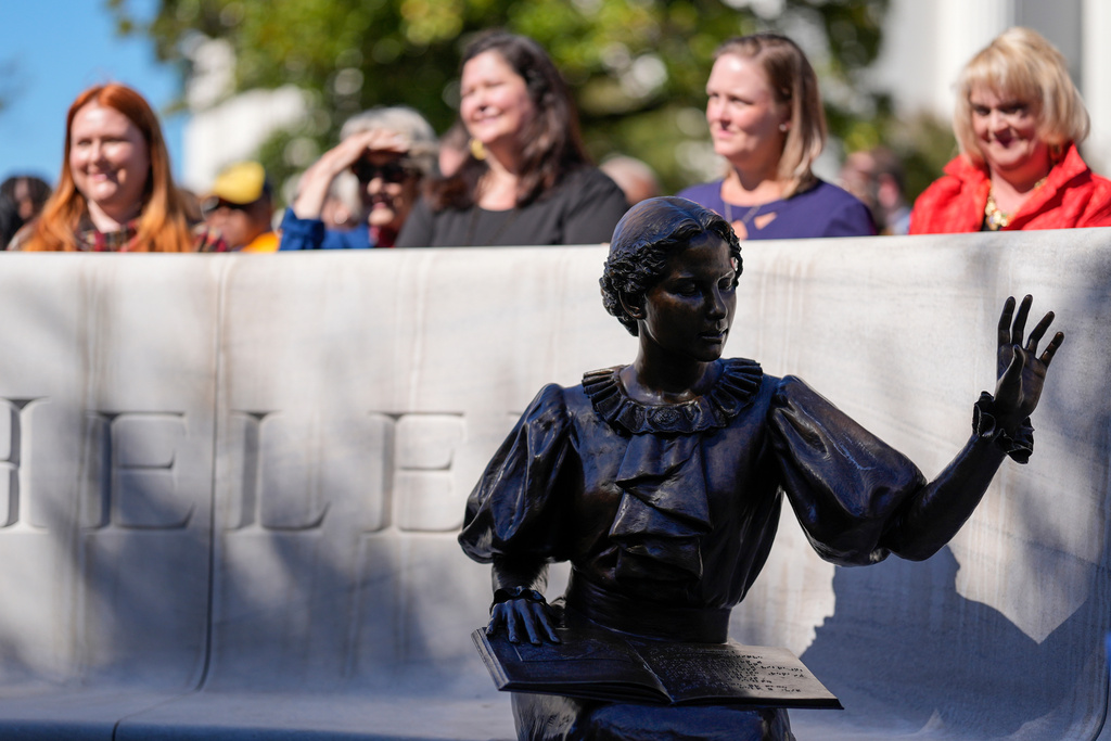People view a newly unveiled statue of Helen Keller on the grounds of the Alabama State Capitol, Friday, Oct. 24, 2025, in Montgomery, Ala. (AP Photo/Mike Stewart)