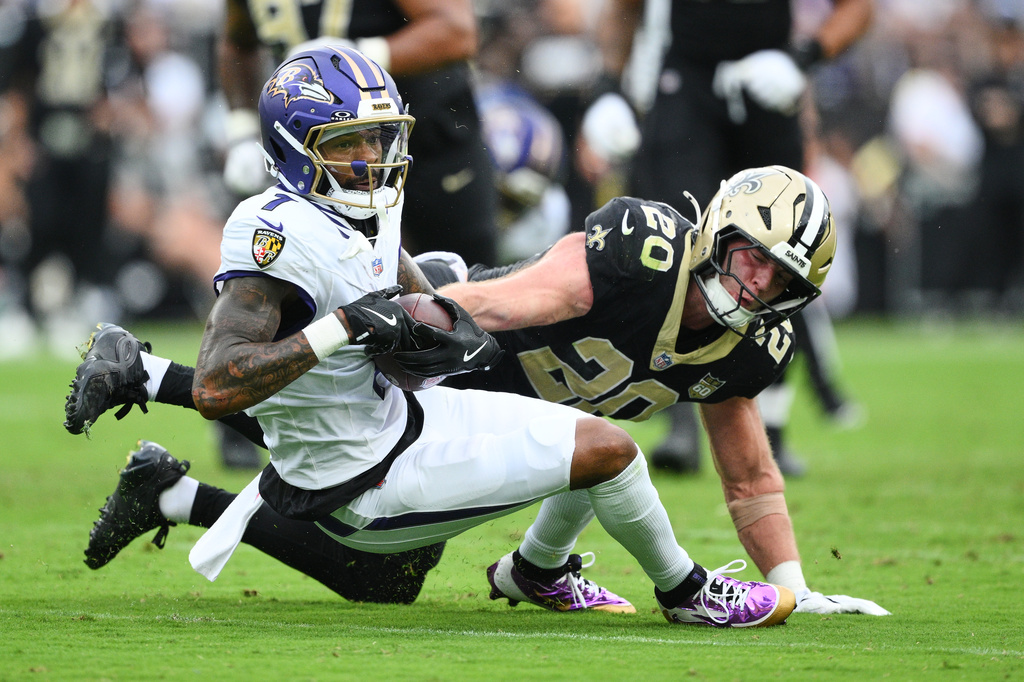 Baltimore Ravens wide receiver Rashod Bateman (7) carries against New Orleans Saints linebacker Pete Werner (20) in the second half of an NFL football game in Baltimore, Sunday, Sept. 20, 2026. (AP Photo/Nick Wass)