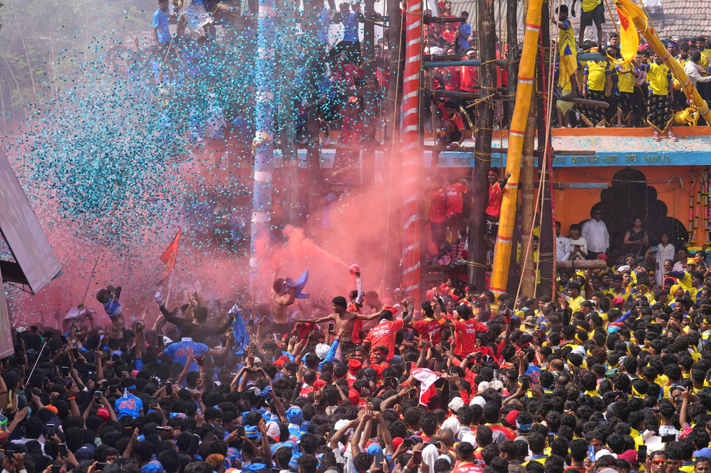 Members of the Agri-Koli community celebrate as they compete to erect ceremonial bamboo poles in a centuries-old annual tradition honoring the local goddess Raiba Devi, in Rave village near Mumbai, India, Friday, April 17, 2026. (AP Photo/Rafiq Maqbool)