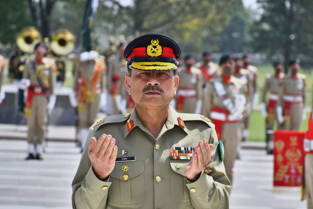 FILE - In this photo released by the Inter Services Public Relations, newly elevated Field Marshal General Asim Munir prays after laying wreath on the Martyrs monument during a special guard of honor ceremony at General Headquarters, in Rawalpindi, Pakistan, May 21, 2025. (Inter Services Public Relations via AP, File)