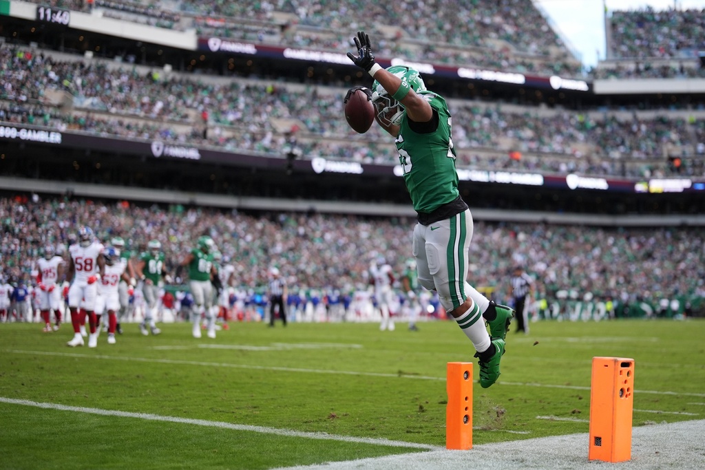 Philadelphia Eagles running back Saquon Barkley scores a touchdown during the first half of an NFL football game against the New York Giants on Sunday, Oct. 26, 2025, in Philadelphia. (AP Photo/Matt Slocum)