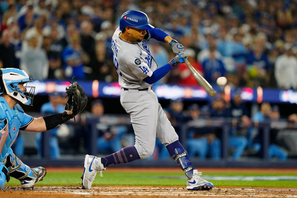 Los Angeles Dodgers' Mookie Betts (50) hits a two-run single against the Toronto Blue Jays during the third inning in Game 6 of baseball's World Series in Toronto on Friday, Oct. 31, 2025. (Frank Gunn/The Canadian Press via AP)
