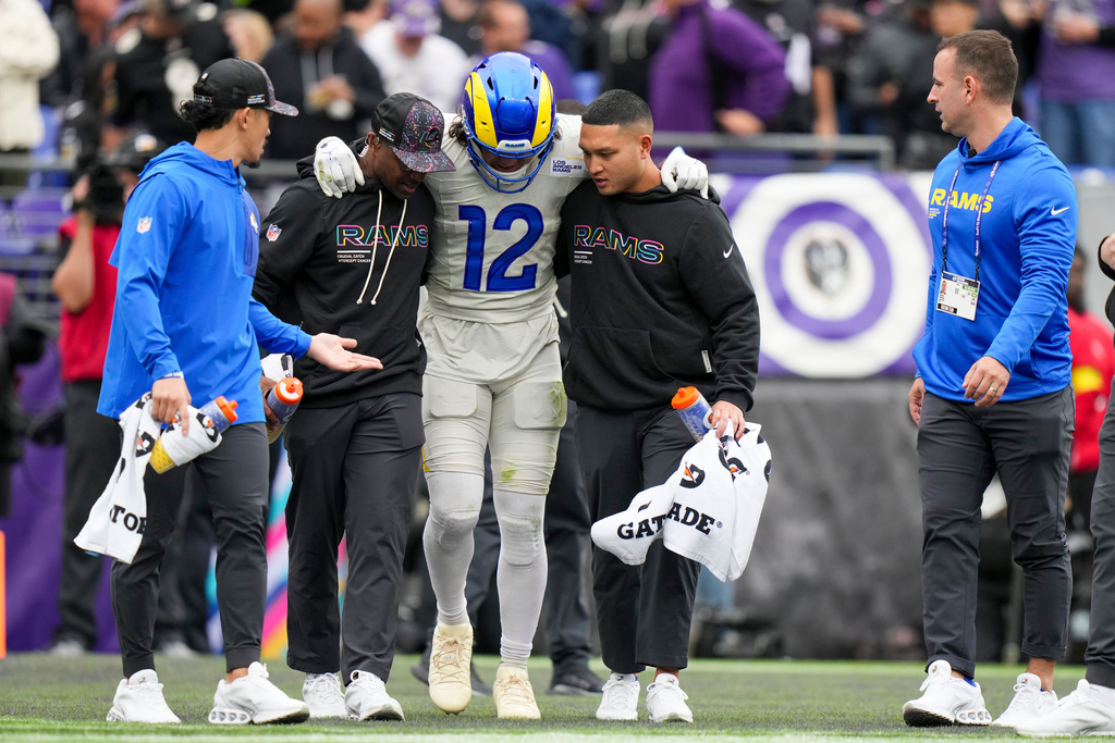 Trainers help Los Angeles Rams wide receiver Puka Nacua off the field during the first half of an NFL football game against the Baltimore Ravens Sunday, Oct. 12, 2025, in Baltimore. (AP Photo/Stephanie Scarbrough)