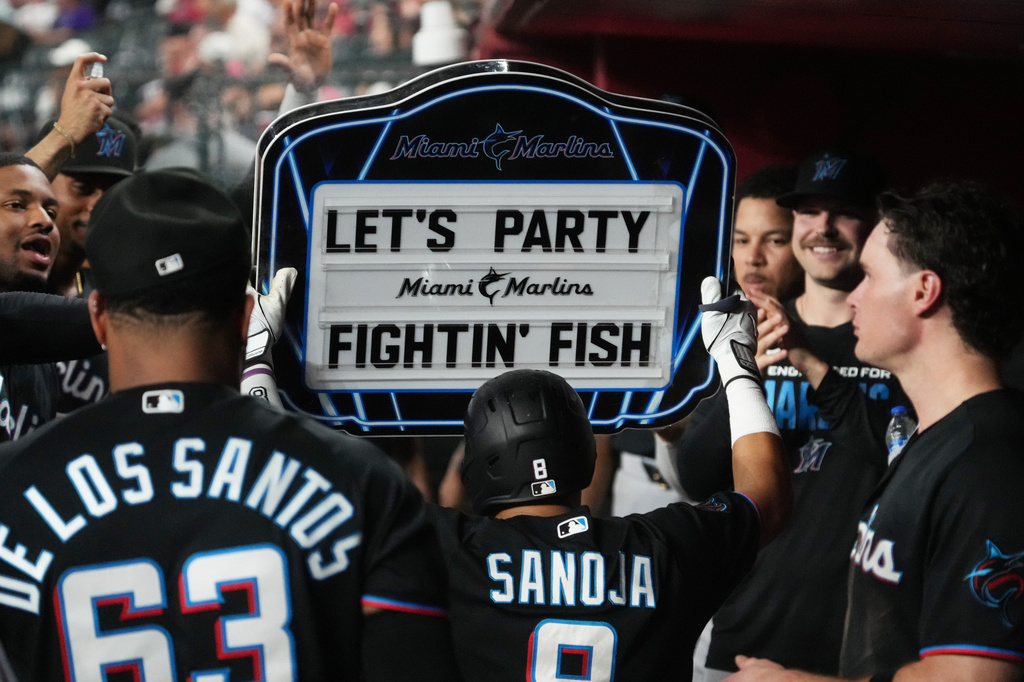 Miami Marlins' Javier Sanoja celebrates with teammates after hitting a solo home run against the Arizona Diamondbacks in the fourth inning of a baseball game, Monday, Sept 14, 2026, in Phoenix. (AP Photo/Rick Scuteri)