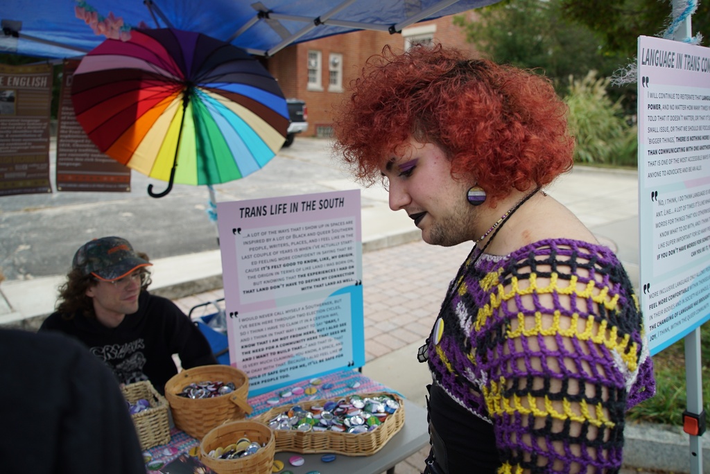 Phoenix Bilodeau stops at a booth during Pride Fest in Wake Forest, N.C., on Saturday, Oct. 11, 2025. Bilodeau, who is trans, said they feel in danger in the current political climate. (AP Photo/Allen G. Breed)