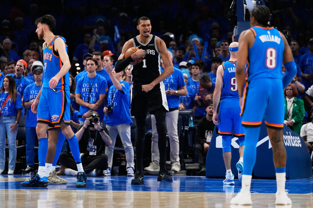 San Antonio Spurs forward Victor Wembanyama (1) celebrates after a dunk during the second overtime of Game 1 in a third-round NBA basketball playoffs series against the Oklahoma City Thunder Monday, May 18, 2026, in Oklahoma City. (AP Photo/Tony Gutierrez)