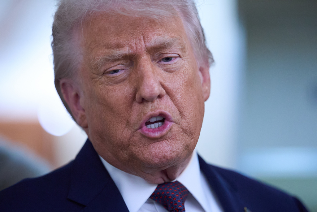 President Donald Trump speaks with reporters aboard Air Force One after leaving the World Economic Forum in Davos for Washington, Thursday, Jan. 22, 2026. (AP Photo/Evan Vucci)