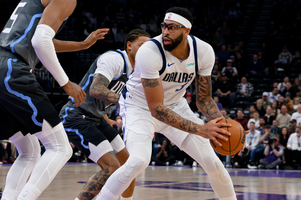 Dallas Mavericks forward Anthony Davis, right, posts up against Utah Jazz guard Keyonte George, center, during the first half of an NBA basketball game, Thursday, Jan. 8, 2026, in Salt Lake City. (AP Photo/Tyler Tate)