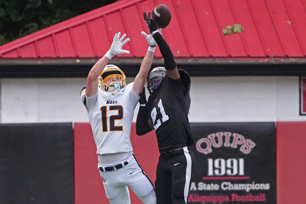 Aliquippa High School's Javonte Cain (21) breaks up a pass intended for Mars High School receiver Smyth Dunaway (12) during a high school football game at Heinz Field in Aliquippa, Pa., Friday, Sept. 4, 2026. (AP Photo/Gene J. Puskar)