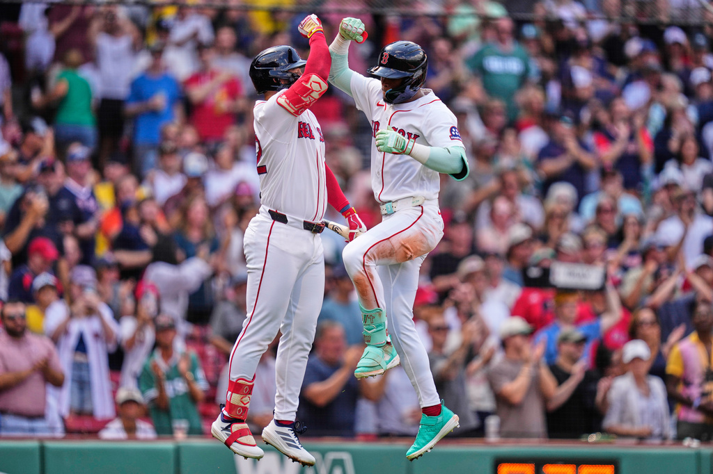 Boston Red Sox's Ceddanne Rafaela, right, is congratulated by Wilyer Abreu after hitting a solo home run in the fourth inning during the first baseball game of a doubleheader against the Baltimore Orioles, Wednesday, July 22, 2026, in Boston. (AP Photo/Charles Krupa)