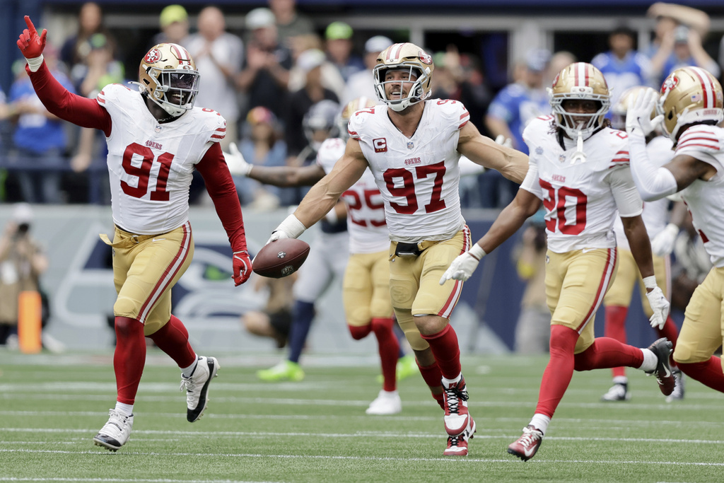 San Francisco 49ers defensive end Nick Bosa (97) runs down the field with the ball during the second half of an NFL football game against the Seattle Seahawks, Sunday, Sept. 7, 2025, in Seattle. (AP Photo/John Froschauer)