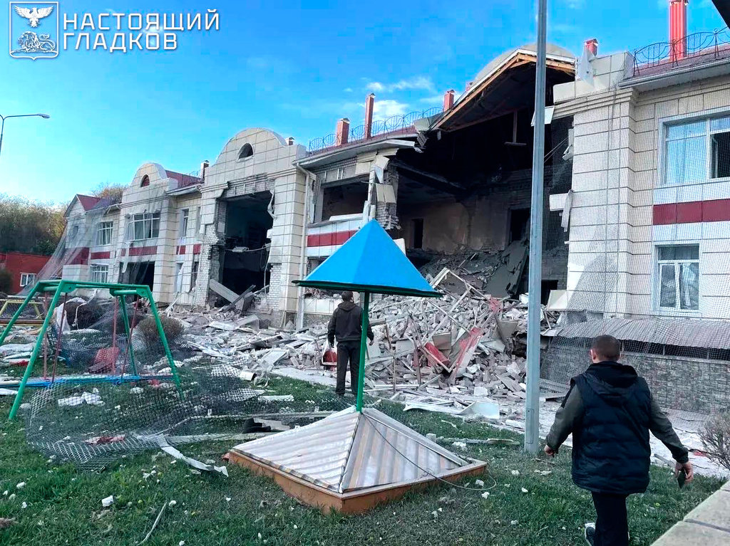 In this photo, released by Belgorod regional governor Vyacheslav Gladkov's Telegram channel, investigators look at the side of a social facility damaged by the Armed Forces of Ukraine in the village of Dobroye, Grayvoron district of Belgorod region, Russia, on Tuesday, April 28, 2026. (Belgorod Region Governor Vyacheslav Gladkov Telegram channel via AP)