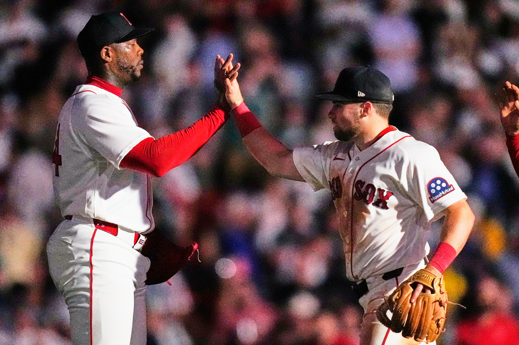 Boston Red Sox's Aroldis Chapman, left, celebrates with Caleb Durbin, right, after their team defeated the New York Yankees, Thursday, June 25, 2026, in Boston. (AP Photo/Charles Krupa)