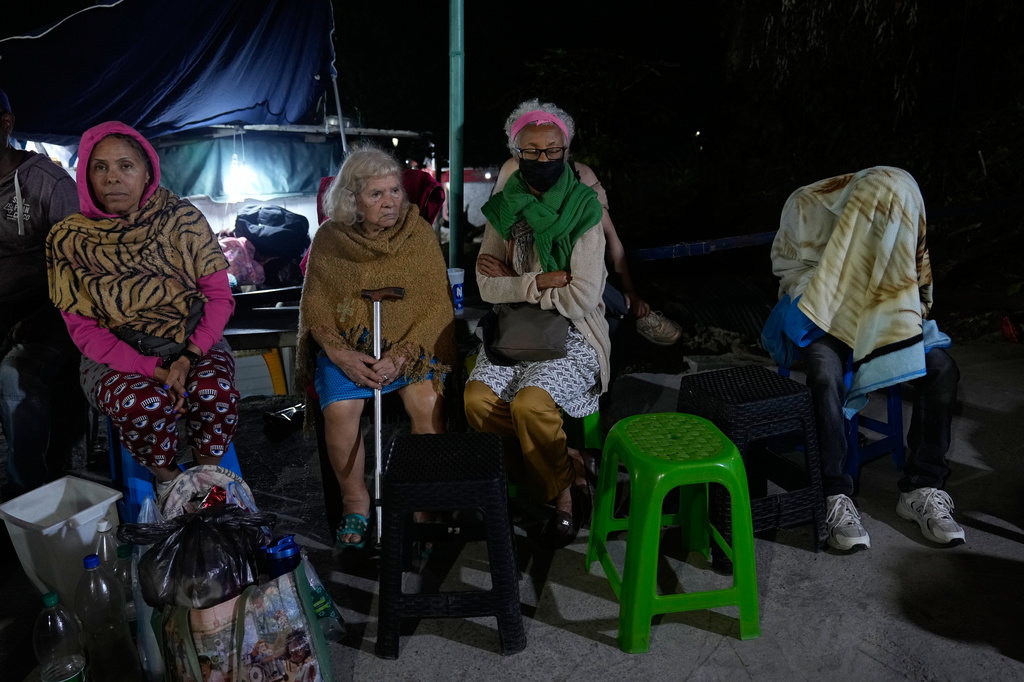 People remain outside their homes following an earthquake in Caracas, Venezuela, Thursday, June 25, 2026. (AP Photo/Ariana Cubillos)