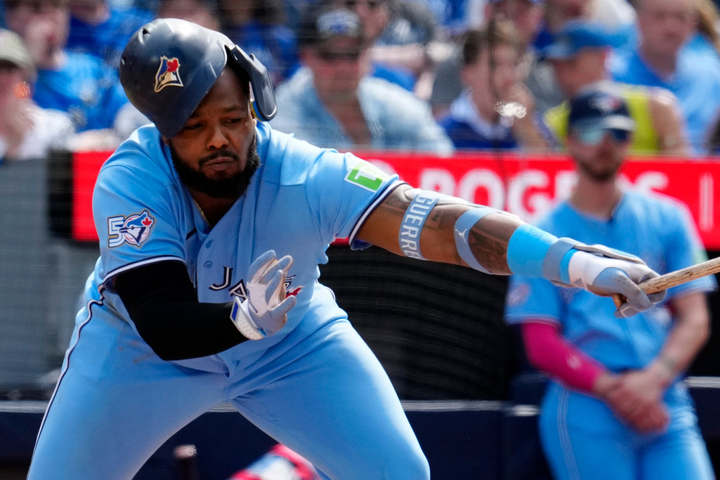 Toronto Blue Jays' Vladimir Guerrero Jr. (27) loses his helmet while swinging for a strike during in the fourth inning of a baseball game against the Baltimore Orioles, Saturday, June 6, 2026, in Toronto. (Frank Gunn/The Canadian Press via AP)