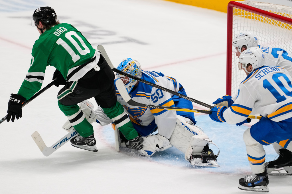 Dallas Stars center Oskar Back (10) is tripped by St. Louis Blues goaltender Jordan Binnington (50) in the second period of an NHL hockey game Wednesday, Feb. 4, 2026, in Dallas. (AP Photo/Tony Gutierrez)