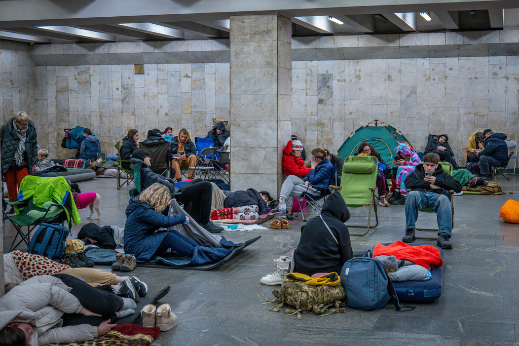 People hide in a metro station, being used as a bomb shelter, during a Russian drones attack in Kyiv, Ukraine, early Friday, Nov. 14, 2025. (AP Photo/Dan Bashakov)