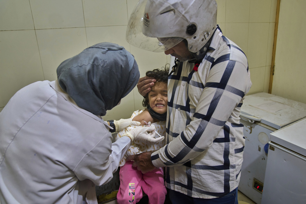Rehmat Ashraf, 6, who was attacked by a dog outside her house, grimaces as she receives a dose of vaccine at the anti-rabies clinic at a hospital in Srinagar, Indian controlled Kashmir, Thursday, Sept. 18, 2025. (AP Photo/Dar Yasin)