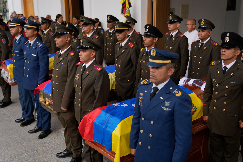 Military personnel stand by the coffins of soldiers killed in the U.S. capture of Venezuelan President Nicolas Maduro and his wife in Caracas, Venezuela, Wednesday, Jan. 7, 2026. (AP Photo/Ariana Cubillos)