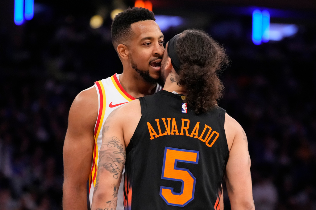 Atlanta Hawks guard CJ McCollum, left, argues with New York Knicks guard Jose Alvarado (5) during the second half in Game 2 of a first-round NBA playoffs basketball series, Monday, April 20, 2026, in New York. (AP Photo/Yuki Iwamura)