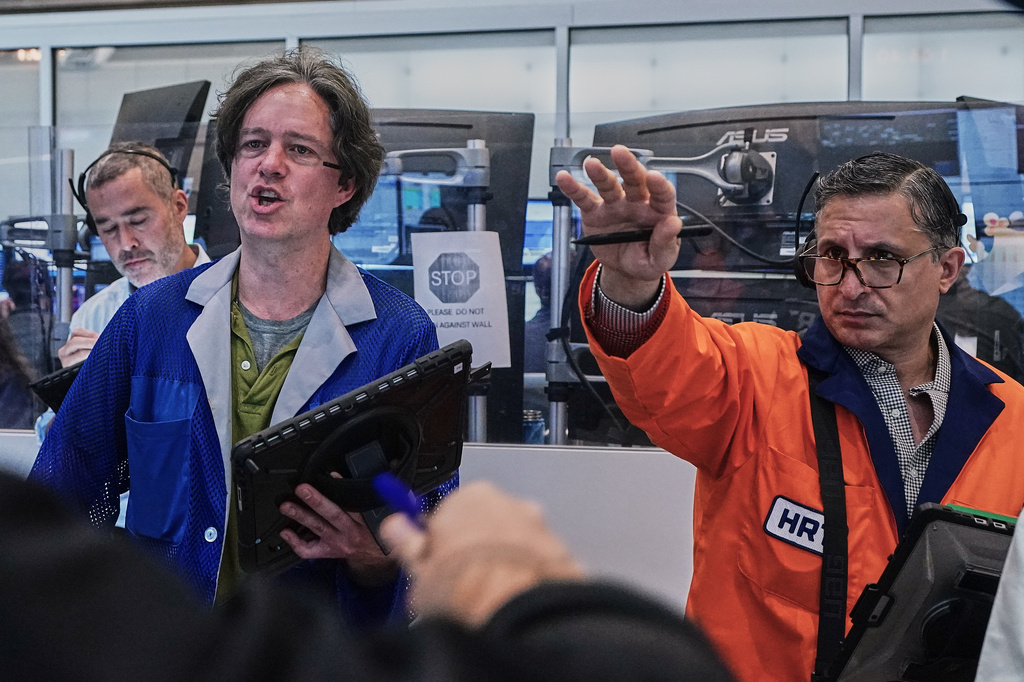 Options traders Justin Kanda, Doran Swan, and Ravi Bhandari. left to right, work on the floor of the New York Stock Exchange, Thursday, June 25, 2026. (AP Photo/Richard Drew)