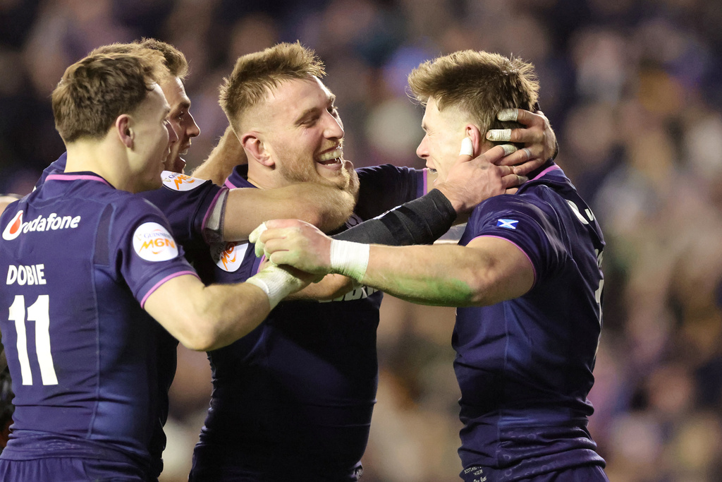 Scotland's Huw Jones, right, celebrates scoring a try with teammates during the Six Nations rugby union match between Scotland and England in Edinburgh, Scotland, Saturday Feb. 14, 2026. (Steve Welsh/PA via AP)