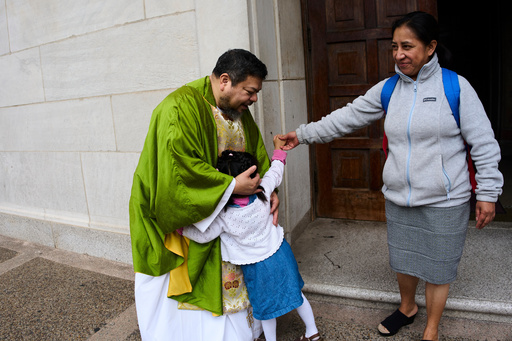 The Rev. Carlos Reyes greets parishioners after celebrating Mass at the Shrine of the Sacred Heart, a Catholic church in Washington, Sunday, Oct. 12, 2025. (AP Photo/Luis Andres Henao) The Rev. Carlos Reyes greets parishioners after celebrating Mass at the Shrine of the Sacred Heart, a Catholic church in Washington, Sunday, Oct. 12, 2025. (AP Photo/Luis Andres Henao)