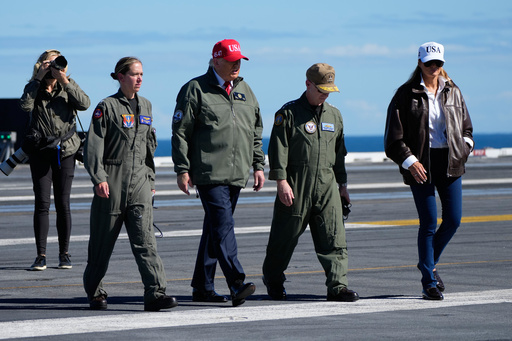 President Donald Trump and first lady Melania Trump walk on the flight deck as part of the Navy's 250th anniversary celebration, aboard the USS George H.W. Bush aircraft carrier in the Atlantic Ocean off the coast of Norfolk, Va., Sunday, Oct. 5, 2025. (AP Photo/Alex Brandon) President Donald Trump and first lady Melania Trump walk on the flight deck as part of the Navy's 250th anniversary celebration, aboard the USS George H.W. Bush aircraft carrier in the Atlantic Ocean off the coast of Norfolk, Va., Sunday, Oct. 5, 2025. (AP Photo/Alex Brandon)