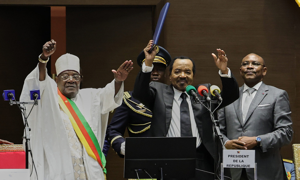 Cameroon's President Paul Biya, second from right, raises his hand after being sworn in for a new term during his inauguration ceremony at the National Assembly in Yaounde, Cameroon, Thursday, Nov. 6, 2025. (AP Photo/Angel Ngwe)